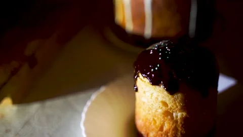 Baking is watered with chocolate syrup white color Stock Footage 130565707