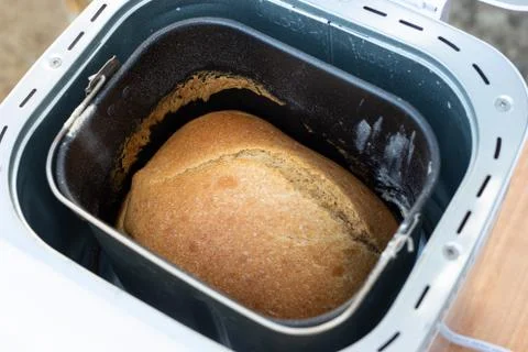 Baking white bread at home, fragrant fresh bun in a bread machine Stock Photos