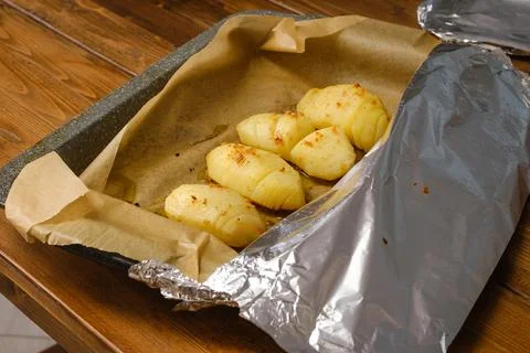 Baking whole half slices potato in oven Stock Photos