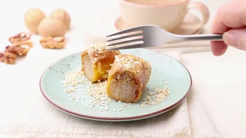 Baklava is cut with a fork on a whte background. Stock Footage 126294506