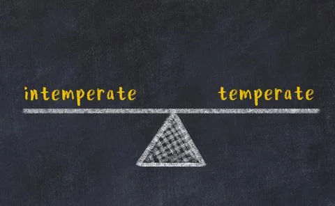 Balance between intemperate and temperate. Chalkboard drawing on black chalkb Foto stock