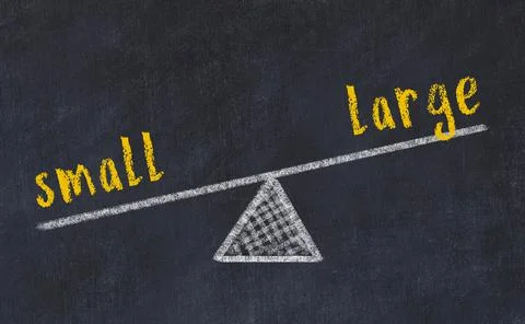 Balance between small and large. Chalkboard drawing on black chalkboard Foto stock