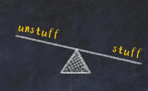 Balance between unstuff and stuff. Chalkboard drawing on black chalkboard Foto stock