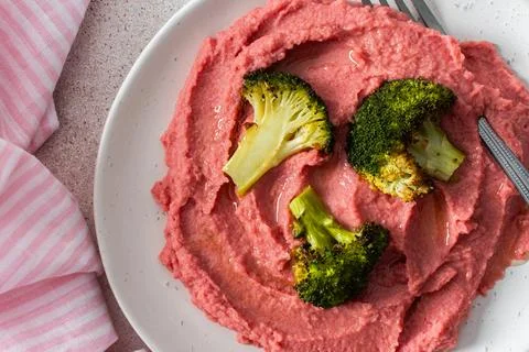 A balanced breakfast with beetroot hummus and broccoli offering a wholesome s Stock Photos