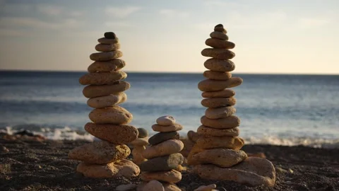 Balanced pebble pyramid with warm sunset... | Stock Video | Pond5
