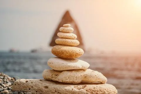 Balanced rock pyramid on the pebbled beach is a study in harmony and balance Stock Photos