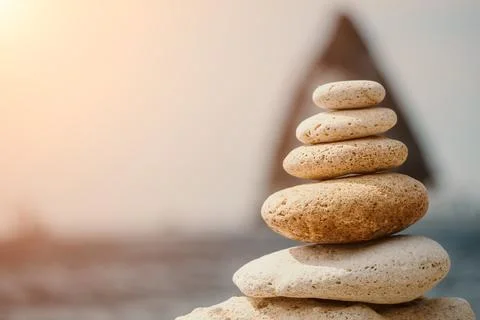 Balanced rock pyramid on the pebbled beach is a study in harmony and balance Stock Photos