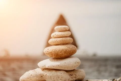 Balanced rock pyramid on the pebbled beach is a study in harmony and balance Stock Photos