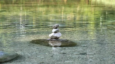 Balanced Rock Zen Stack in water of lake Stockbeeldmateriaal 138376659