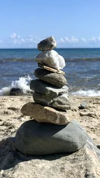 Balanced Stack of Rocks on Sandy Beach Shore Stock Photos