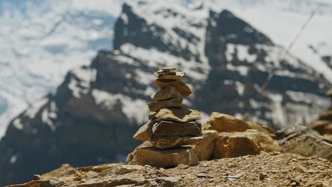 Balanced stack of small flat stones lays on edge of highland sunny viewpoint Stock Footage 124676959