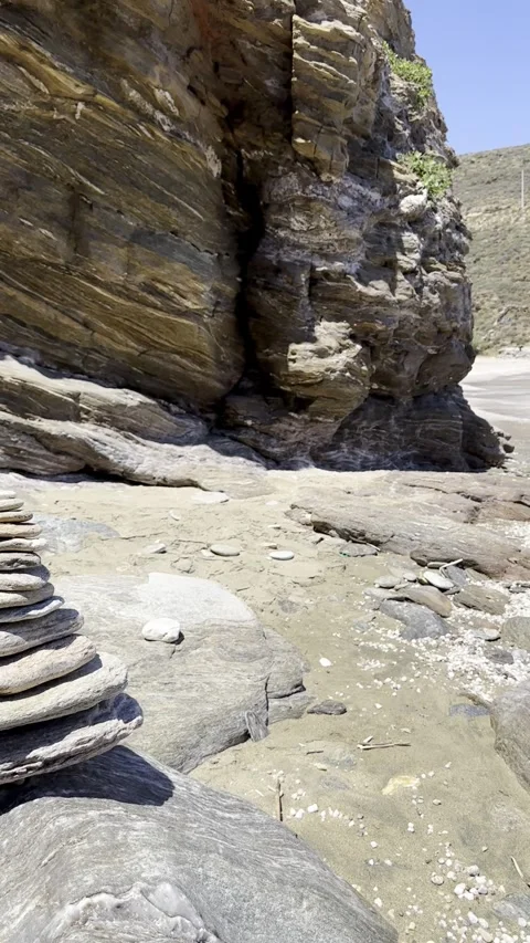 Balanced Stone Cairn on Rocky Seashore with Coastal Cliffs Stock Footage 336965065