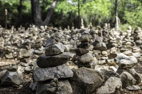 Balanced Stone Cairns in Forest Clearing With Stacked Rocks and Tranquil Na.. Stock Photos
