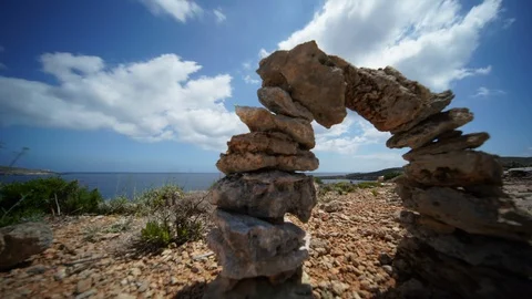 Balanced stone pyramid. Stacked stones pyramid on the background of floating Stock Footage