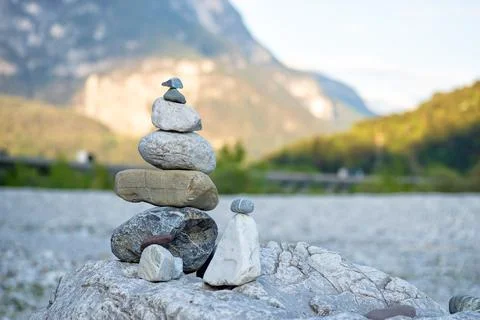 Balanced stone tower in mountain valley Photos