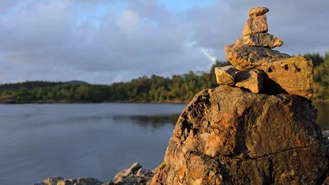Balanced stone tower with sea and islands in the background Stock Footage 341895703