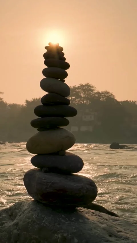 Balanced stones on a pebble beach during sunset (Vertical). Stock Footage 303873257