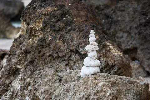 Balanced stones stack close up on sea beach Stock Photos