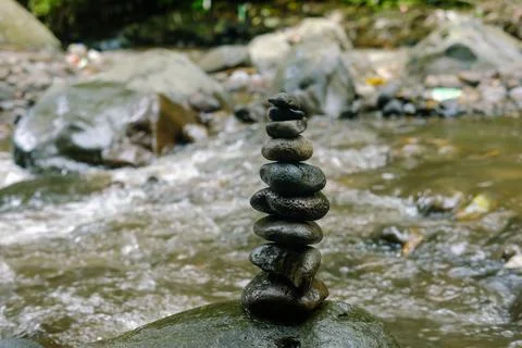 Balanced Zen Stones Stack in Flowing River Stream  Natures Perfect Balance. Stock Photos