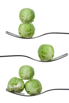 Balancing brussel sprouts on forks against white Stock Photos