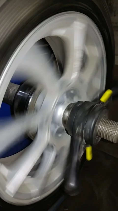 Balancing car wheel on professional balancer machine in service station Stock Footage 333122700