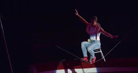 Balancing on a chair on a string, equilibrist performing on stage of a circus 4k Stock Footage 147191233