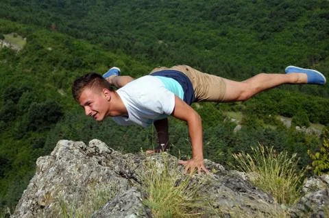 Balancing on the Edge of the Rock Stock Photos