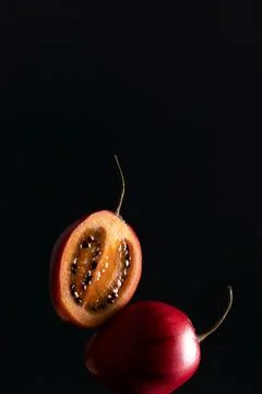Balancing Exotic fruit Tamarillo, also called tree tomato on dark background Stock Photos