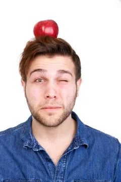 Balancing red apple on head Stock Photos