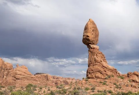 Balancing Rock with storm clouds, Arches National Park, Moab, UT Stock Photos