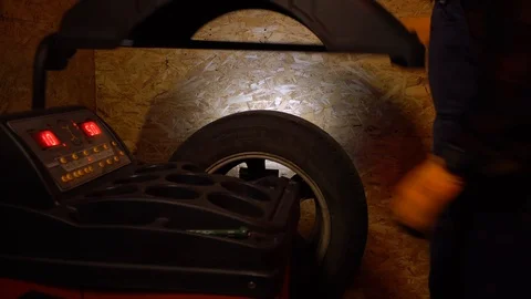 Balancing wheel with machine balancer at service Stock Footage 126527555