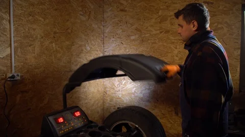 Balancing wheel with machine balancer at service.Balancing machines car wheels Stock Footage 126527511