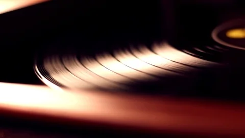 A balck vinyl disc is spinning in a player Stock Footage 103205059