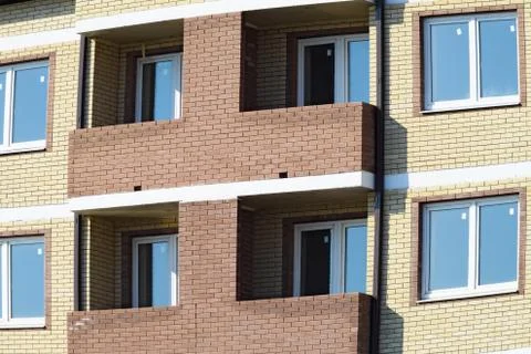 Balconies and windows of a multi-storey new house Stock Photos