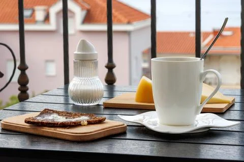 Balcony breakfast with coffee bread cheese and sugar dispenser. Mediterrane.. Stock Photos