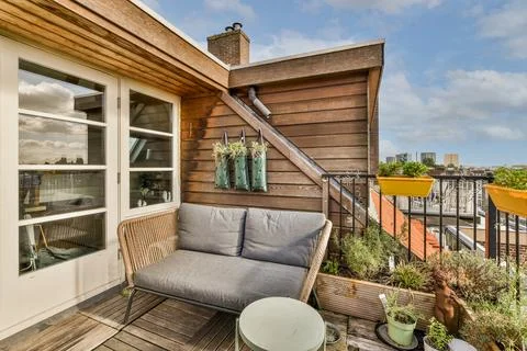 A balcony with a couch and a table Stock Photos