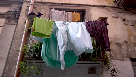 Balcony with drying laundry in the wind and a black cat Stock Footage 240826564