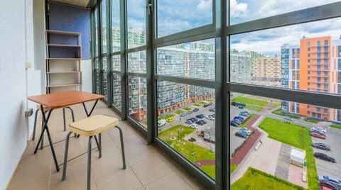 Balcony interior with chairs and table of modern apartment with a view on the Stock Photos