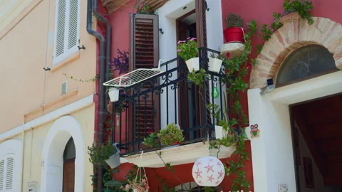 Balcony plants building facade lantern handheld panning shot Vídeos de archivo 346086130