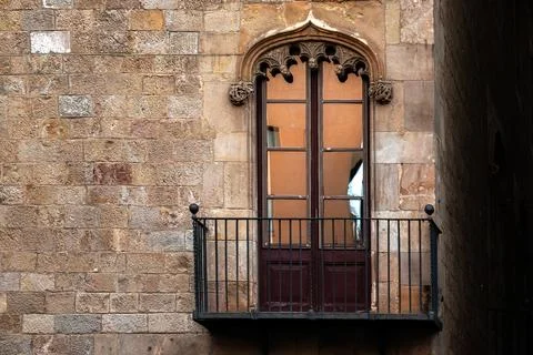 Balcony on a stone wall. Stock Photos