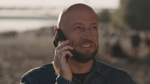 Bald and handsome man in his mid-forties with a stylish beard is standing on the Stock Footage 140133905