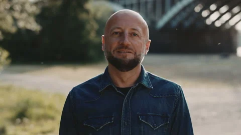 Bald and handsome man in his mid forties with a stylish beard is standing is Stock Footage 146522634