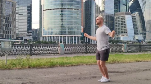 Bald athletic man jumping rope Stock Footage 201303385