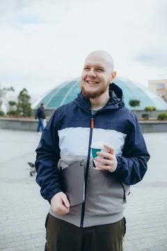 Bald bearded man drinking coffee outdoors Stock Photos