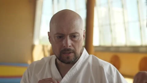 A bald bearded man gets an elbow strike in the fac at training field Stock Footage 137263024