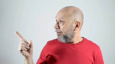 Bald bearded man pointing his finger to the right side showing surprise. Stock Footage 271576607