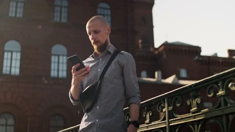 Bald bearded man using smart phone surfing social media Stock Footage 157992074