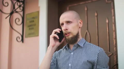 Bald bearded man using smart phone having a business conversation Stock Footage 157992293
