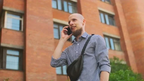 Bald bearded man using smart phone having a conversation Stock Footage 157992587