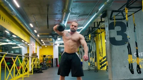 Bald bodybuilder exercising in the gym. Raises the barbell, dumbbells. Stock Footage 238777043